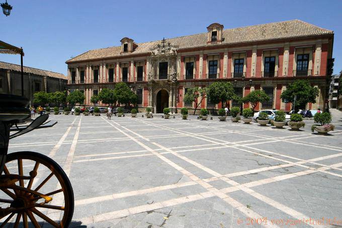 Pink facade of the Palacio Arzobispal on the place of Triunfo, Seville - Spain