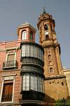 Rounded balconies in the Plaza de San Sebastián and bell tower of the Iglesia San Sebastián, Antequera, Spain.