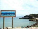 Opposite, the indication Mediterranean Sea on the dike leading to the Isla de Tarifa, Spain.