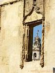 Antique window with views of the Giralda, Cordoba, Spain.