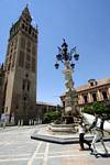 Perspective of the Giralda from the fountain in the Plaza del Triunfo, Seville, Spain.