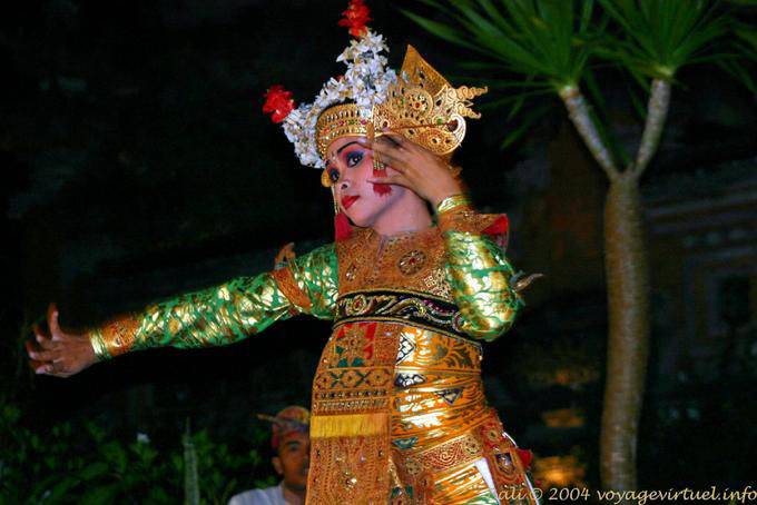 Dancer with gold embroidered dress and headdress decorated with flowers, Barong dance - Bali