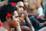 Young men hibiscus flower Uluwatu Kecak dance, Bali.