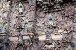 Sangsit, deities heads and demons out of the wall, Pura Beji, Bali.