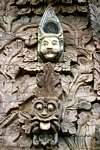 Wall sculptures laughing or pulling the tongue, Pura Beji, Bali.