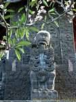 Statue in front of the relief Maduwe Karang, Bali.