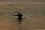 Fisherman throwing a round net, Jimbaran, Bali.