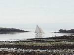 Low tide sailboat passing to advanced Vil in Roscoff, Brittany, France.