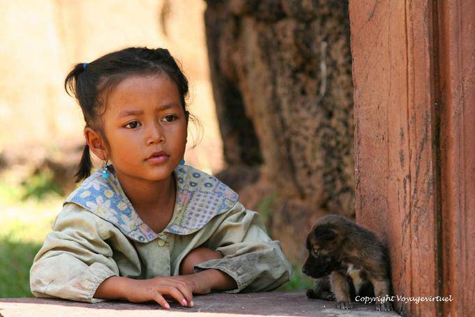 Little girl and puppy on the site of Banteay Srei, Angkor, Cambodia
