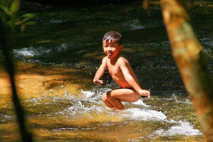 Child swimming, Kbal Spean website, Angkor, Cambodia