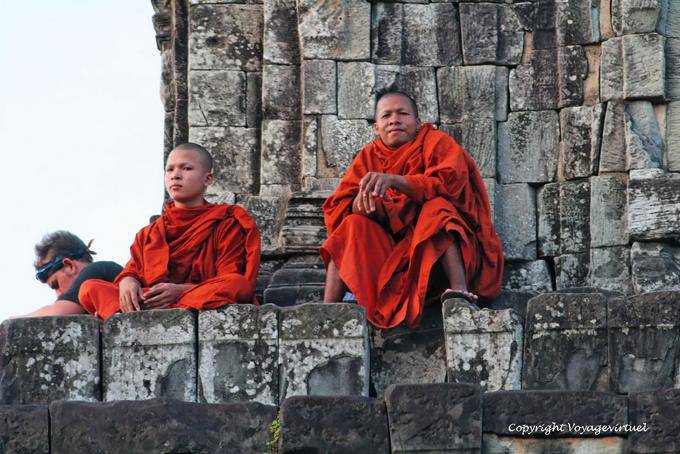 The men in red Phnom Bakheng, Angkor, Cambodia