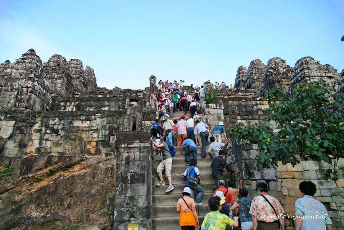 Tourists on the stairs of Phnom Bakheng, Angkor, Cambodia