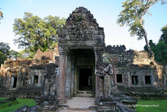 Guards at entrance stick Preah Khan, Angkor, Cambodia