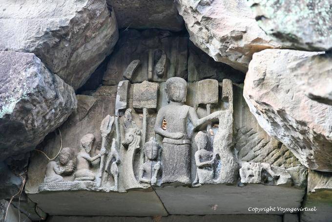 An offering sitting carving Preah Khan pediment, Angkor, Cambodia