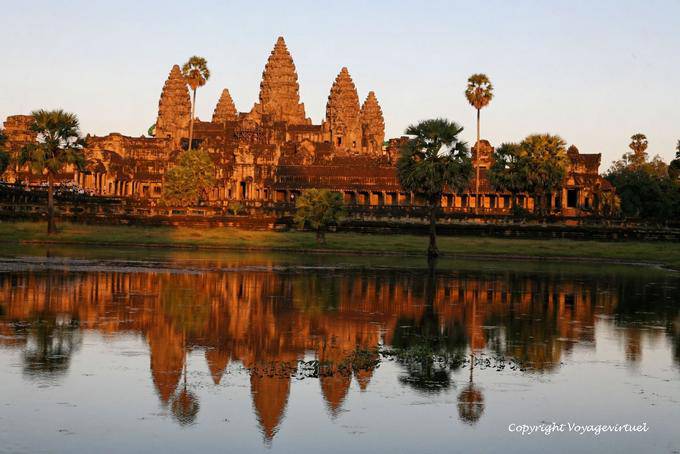 Angkor Wat by a glowing evening reflection in a pond, Angkor, Cambodia