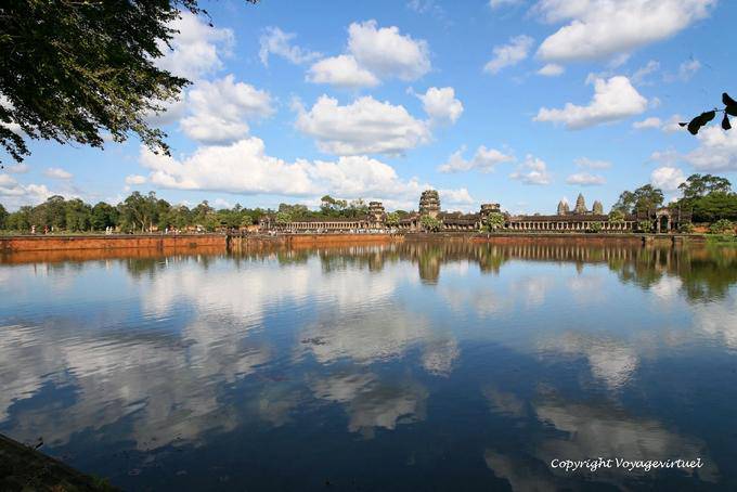 Clouds and blue sky reflecting in the large moat of Angkor Wat, Angkor, Cambodia