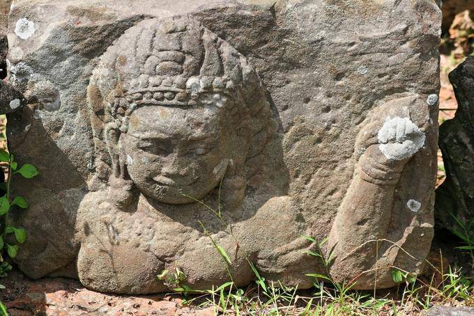 Sculpture fragment on a stone placed on the ground, Elephants Terrace, Angkor, Cambodia