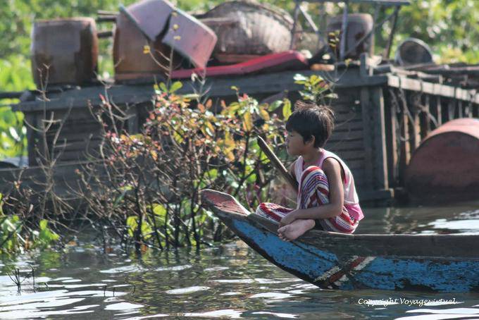 Children at the bow of a boat, Tonle Sap Lake - Cambodia