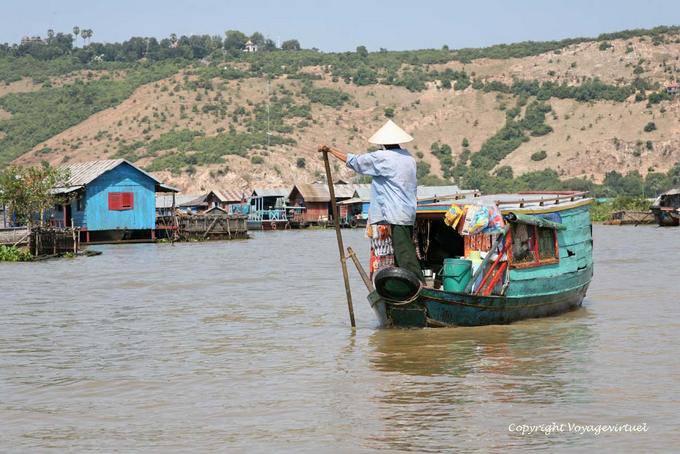 Floating merchant arriving in a village on stilts, Tonle Sap - Cambodia