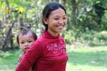Young mother and her child in the back, NH7, Cambodia.