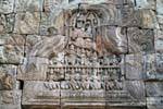 Buddhist scene carved on a pediment, Wat Nokor, Kampong Cham, Cambodia.