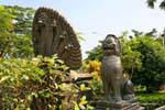 Naga heads and brass guard, garden of the National Museum, Phnom Penh, Cambodia.