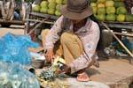 Peeling pineapple market Skun, Cambodia.