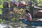 Children at the bow of a boat, Tonle Sap Lake, Cambodia.