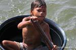 Cabin boy in a plastic bowl, Tonle Sap Lake, Cambodia.