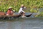 Rower in the wave, Tonle Sap Lake, Cambodia.