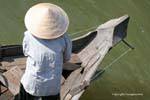 Bow of wood and conical hat, Tonle Sap, Cambodia.