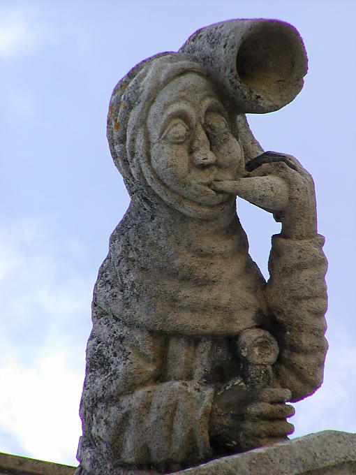 Stone sculpture of a medieval bell-ringer, Amboise Castle, France.