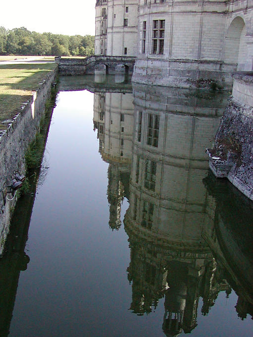 Tours reflected in the moat, Chambord, France.