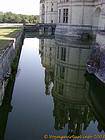 Tours reflected in the moat, Chambord, France.