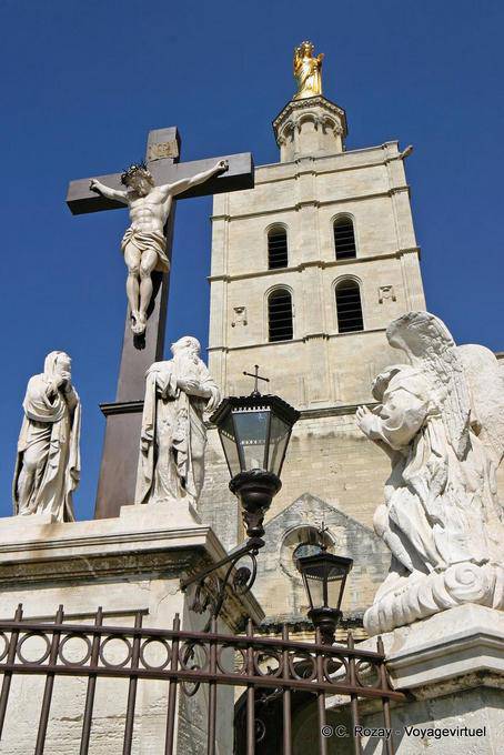 Christ crucified with angel watching, statuary at the foot of Notre Dame des Doms, Avignon, Provence, France