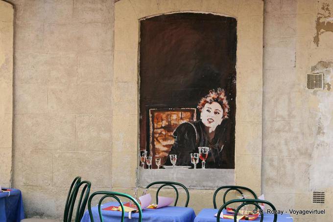 Painting adorning the streets of Mons in amount to the palace in Avignon, Provence, France