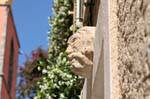 Saint-Tropez, stone head in the wall, France.