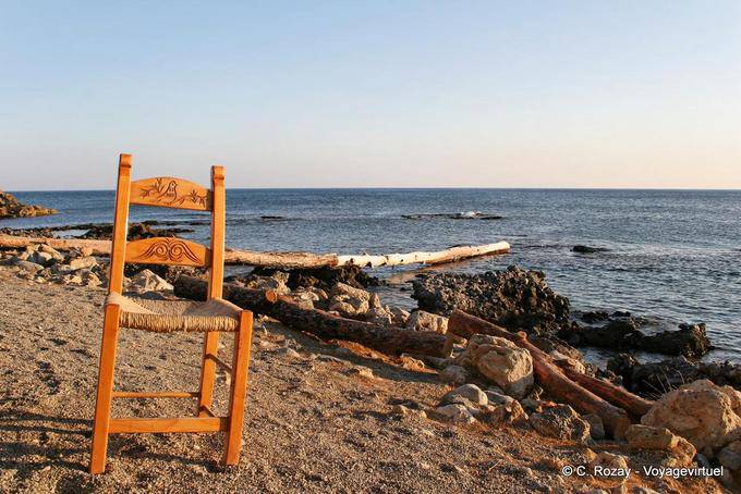 Lonely chair on the beach driftwood, Frangokastello - Crete, Greece