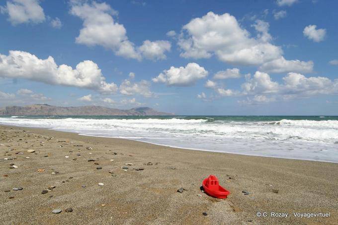 Plastic boat and pebbles on the sand beach, Georgioupoli - Crete, Greece