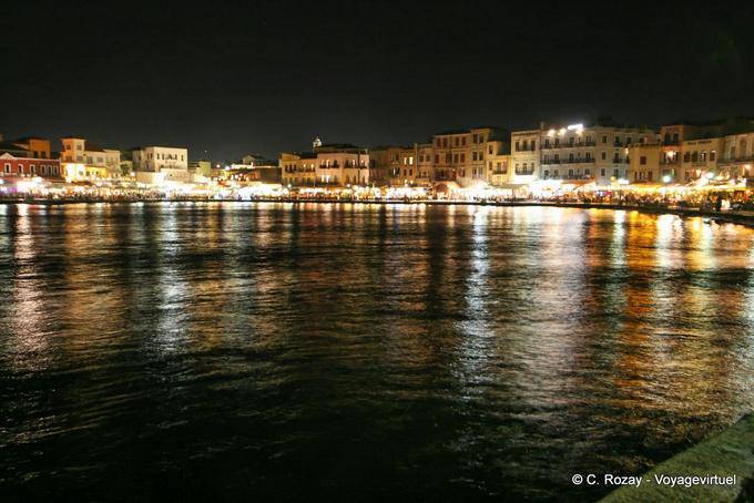 Panorama of the picturesque old port of Chania illuminated - Crete, Greece
