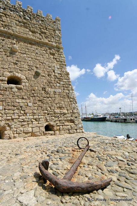 Rusty anchor in front of a wall of the Castello del Molo (Koules), Iraklio (Heraklion) - Crete, Greece