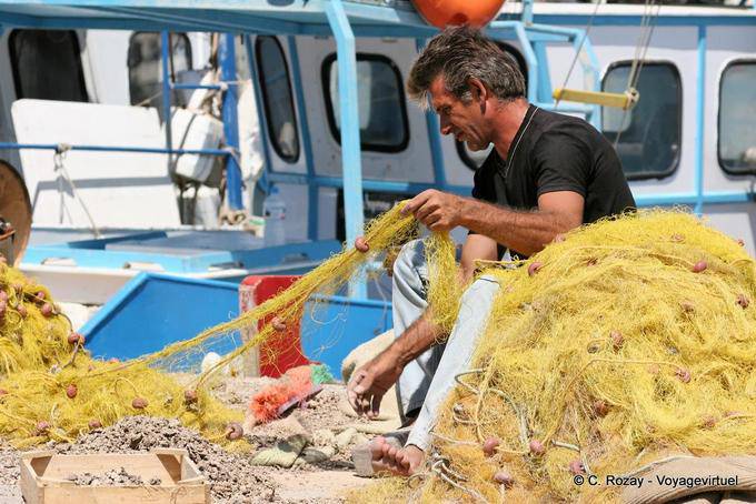 Fisherman cleaning his nets, Iraklio (Heraklion) - Crete, Greece