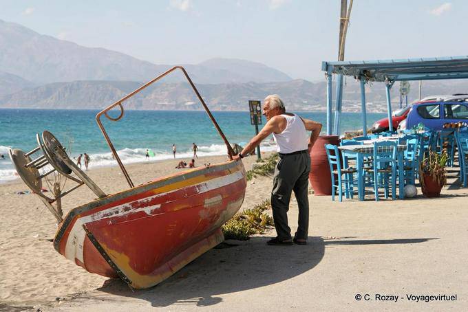 Cretans and his boat before the Kalamaki beach, south of Tymbaki - Crete, Greece
