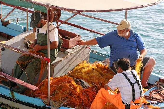 Matala, Mending nets after fishing - Crete, Greece