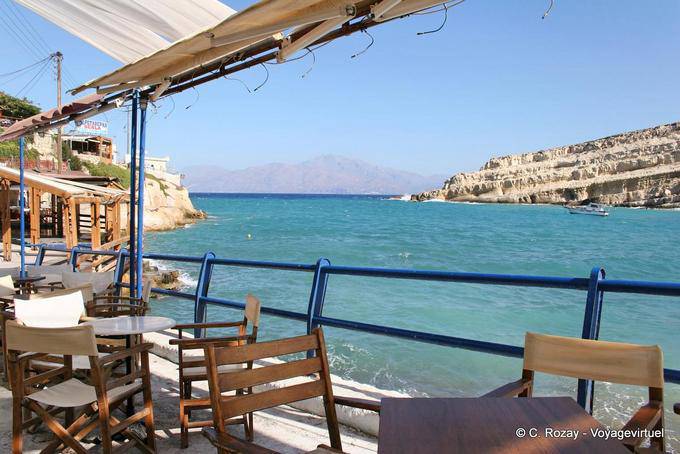 The entrance to the natural harbor from the terrace of a tavern, Matala - Crete, Greece