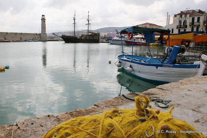 Rethymnon, fishing net and tourist boat in the old harbor - Crete, Greece