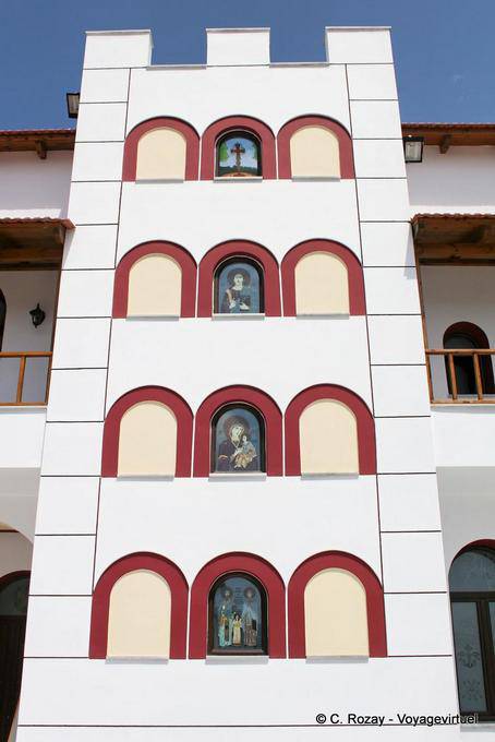 Spili building with religious images in front of Agios Raphail, in the bishopric - Crete, Greece