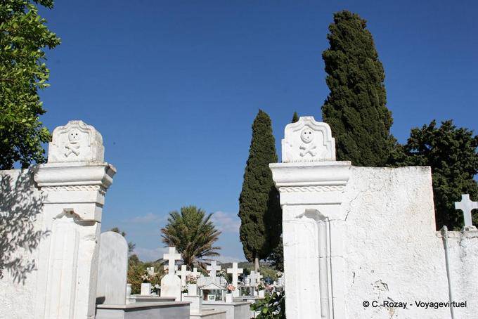 Skulls on the Italian entrance of the cemetery, Vori - Crete, Greece