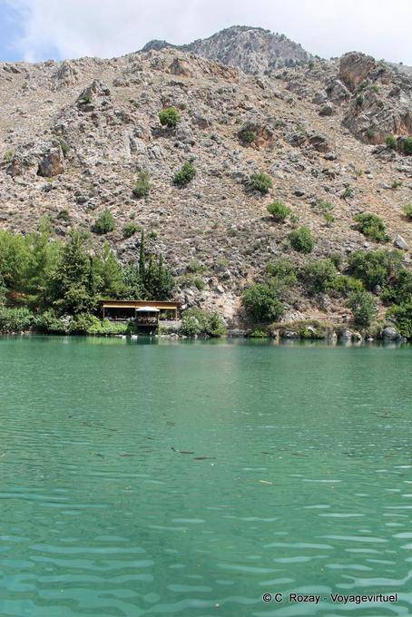 Zaros, fish swimming and restaurant on Lake Volomos - Crete, Greece