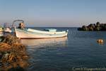 White and blue boat on calm sea, Frangokastello, Crete.